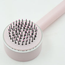 Self-cleaning detangling brush